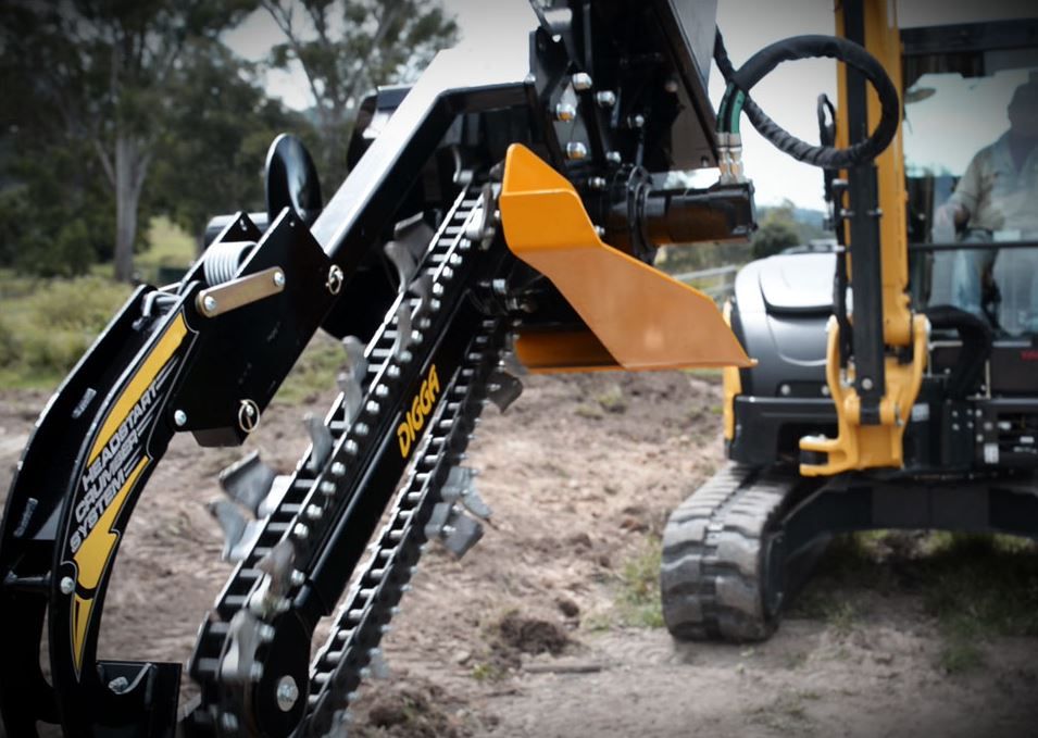 closeup view of a digga skid steer trencher attachment on a skid steer boom arm