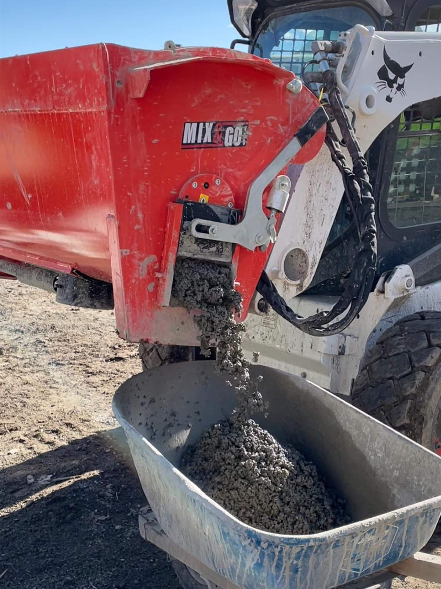 Side dispensing chute on Eterra Skid Steer Concrete Mixer