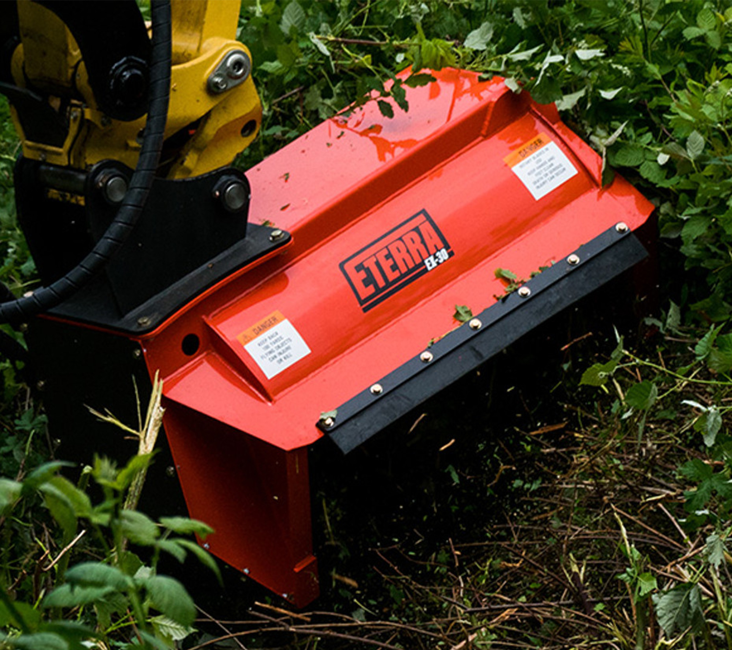 closeup front view of the eterra ex-30 excavator flail mower cutting some brush